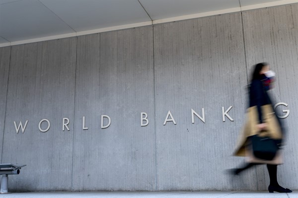 A woman walks past the World Bank building in Washington, April 5, 2021 (AP photo by Andrew Harnik).