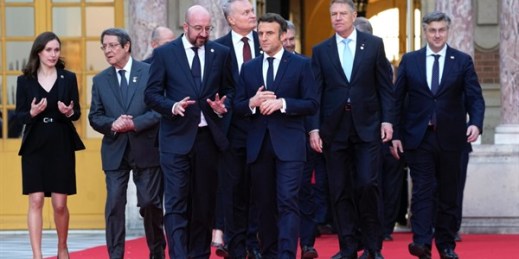 French President Emmanuel Macron speaks with European Council President Charles Michel as they walk to a group photo in Versailles, March 10, 2022 (AP photo by Michel Euler).