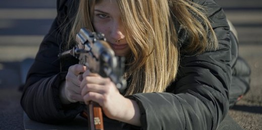 A young woman holds a weapon during a basic combat training for civilians organized by Ukraine’s National Guard, Mariupol, Ukraine, Feb. 13, 2022 (AP photo by Vadim Ghirda).