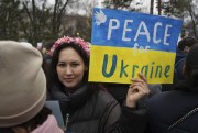 A demonstrator holds a poster reading “Peace for Ukraine” during a protest against the Russian invasion, Almaty, Kazakhstan, March 6, 2022 (AP photo by Vladimir Tretyakov).