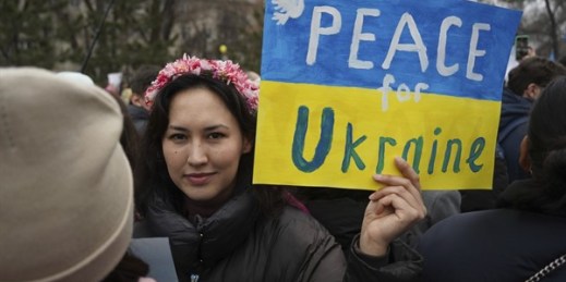 A demonstrator holds a poster reading “Peace for Ukraine” during a protest against the Russian invasion, Almaty, Kazakhstan, March 6, 2022 (AP photo by Vladimir Tretyakov).