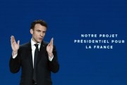 French President Emmanuel Macron delivers a speech next to a screen reading “Our Presidential Project for France” during a presidential campaign news conference, Aubervilliers, France, March 17, 2022 (AP photo by Thibault Camus).