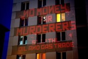 The words “No Money for Murderers, Stop the Oil and Gas Trade” are projected by activists onto the Russian consulate in Frankfurt, Germany, April 4, 2022 (AP photo by Michael Probst).