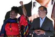 Francia Marquez raises her arm next to presidential candidate Gustavo Petro, at an event presenting her as his running mate in Bogota, Colombia, March 23, 2022 (AP photo by Fernando Vergara).
