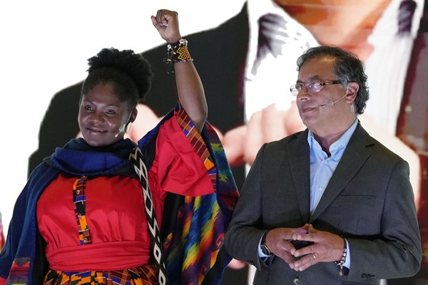 Francia Marquez raises her arm next to presidential candidate Gustavo Petro, at an event presenting her as his running mate in Bogota, Colombia, March 23, 2022 (AP photo by Fernando Vergara).