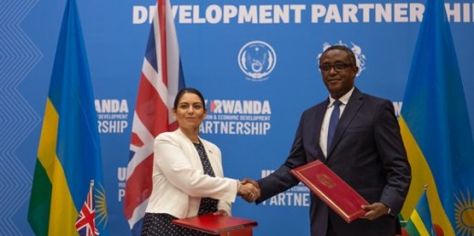 British Home Secretary Priti Patel shakes hands with Rwandan Minister of Foreign Affairs Vincent Biruta after signing what the two countries called an “economic development partnership” in Kigali, Rwanda, April 14, 2022 (AP Photo by Muhizi Olivier).