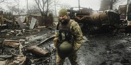 Ukrainian soldiers inspecting the wreckage of a destroyed Russian armored column on a road in Bucha, a suburb just north of the Capital, Kyiv (SIPA photo by Matthew Hatcher via AP Images).
