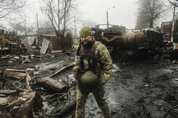 Ukrainian soldiers inspecting the wreckage of a destroyed Russian armored column on a road in Bucha, a suburb just north of the Capital, Kyiv (SIPA photo by Matthew Hatcher via AP Images).