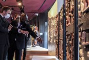 French President Emmanuel Macron looks at Beninese art.