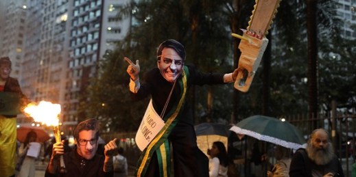 A demonstrator wearing a mask of Brazilian President Jair Bolsonaro and brandishing a fake chainsaw marches in defense of the Amazon in Rio de Janeiro, Brazil, Sept. 5, 2019 (AP photo by Silvia Izquierdo).