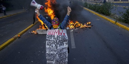 A Mapuche Indigenous woman protests against then-Chilean President Sebastian Pinera in Santiago, Chile, Nov. 4, 2021 (AP photo by Esteban Felix).