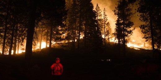 A firefighter monitors the Caldor Fire burning near structures in South Lake Tahoe, Calif., Aug. 30, 2021 (AP photo by Jae C. Hong).