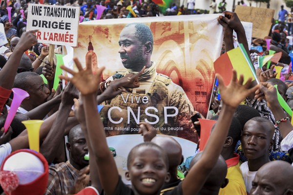 People hold a banner showing Col. Assimi Goita, leader of the junta running Mali, as they demonstrate to show support for the junta in the capital Bamako, Mali, Sept. 8, 2020 (AP photo).