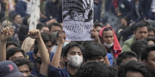 A student holds a poster portraying President Joko Widodo during a rally against postponing the 2024 presidential election, Jakarta, Indonesia, April 21, 2022 (AP photo by Tatan Syuflana).