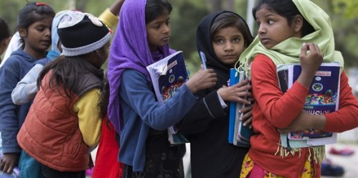 Girls from poor localities wait their turn to show school work to teacher, at a makeshift school in a city park in Islamabad, Pakistan, Nov. 13, 2018 (AP photo by B.K. Bangash).