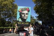 A man holds a placard mocking Australian Prime Minister Scott Morrison during the May Day rally in Sydney, May 1, 2022 (AP photo by Rick Rycroft).