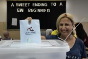 A Lebanese woman casts her vote in parliamentary elections, in Beirut, Lebanon, May 15, 2022 (AP photo by Hussein Malla).