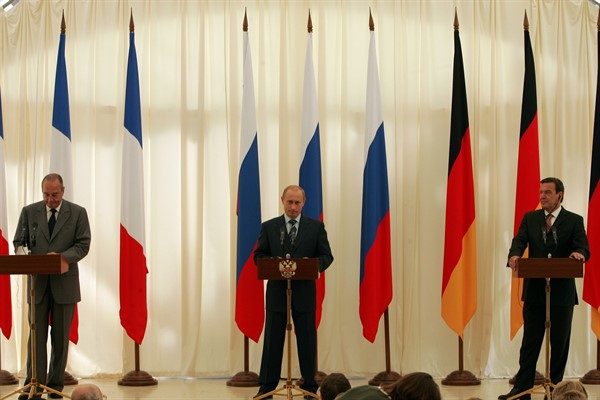 Russian President Vladimir Putin, with then-French President Jacques Chirac and then-German Chancellor Gerhard Schroeder, briefs the media in Svetlogorsk, near Kaliningrad, July 3, 2005 (AP photo by Markus Schreiber).