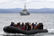 Migrants arrive in Lesbos, Greece, in a dinghy accompanied by a Frontex vessel, February 28, 2020 (AP photo by Michael Varaklas).