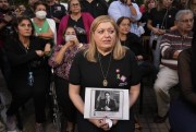 Paraguayan Attorney General Sandra Quinonez holds an image of the late anti-drug prosecutor Marcelo Pecci, Asuncion, Paraguay, May 13, 2022 (AP photo by Jorge Saenz).