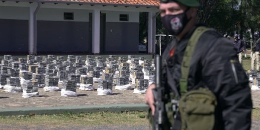 Police stand guard over seized cocaine that is displayed to the press at the Special Forces Police headquarters in Asuncion, Paraguay, July 28, 2021 (AP photo by Jorge Saenz).