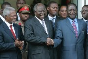 Then-Kenyan President Mwai Kibaki, center, shakes hands with Raila Odinga, right, as former U.N. Secretary-General Kofi Annan, left, looks on, Jan. 24, 2008 in Nairobi, Kenya (AP photo by Karel Prinsloo).