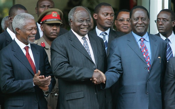 Then-Kenyan President Mwai Kibaki, center, shakes hands with Raila Odinga, right, as former U.N. Secretary-General Kofi Annan, left, looks on, Jan. 24, 2008 in Nairobi, Kenya (AP photo by Karel Prinsloo).