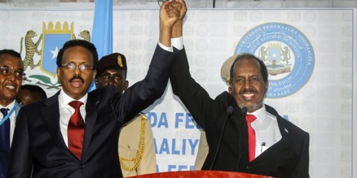 Hassan Sheikh Mohamud, right, marks his election win with incumbent President Mohamed Abdullahi Mohamed, left, in Mogadishu, Somalia, May 15, 2022 (AP photo by Farah Abdi Warsameh).