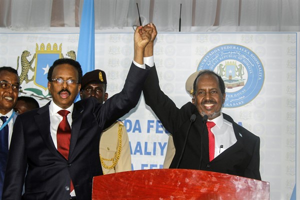Hassan Sheikh Mohamud, right, marks his election win with incumbent President Mohamed Abdullahi Mohamed, left, in Mogadishu, Somalia, May 15, 2022 (AP photo by Farah Abdi Warsameh).