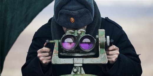 A Russian soldier looks through a binocular during drills in the Rostov region in southern Russia, Dec. 14, 2021 (AP photo).