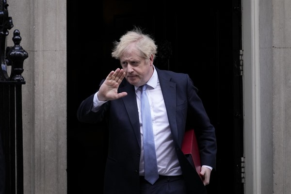 British Prime Minister Boris Johnson waves at the media as he leaves 10 Downing Street to attend the weekly Prime Minister's Questions at the Houses of Parliament, in London, Feb. 9, 2022 (AP photo by Matt Dunham).