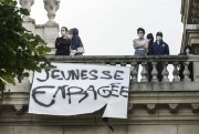 Students standing behind a banner reading “Enraged Youth” hung on the facade of the Sorbonne, Paris, April 14, 2022 (Sipa photo via AP Images).