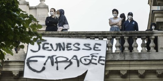 Students standing behind a banner reading “Enraged Youth” hung on the facade of the Sorbonne, Paris, April 14, 2022 (Sipa photo via AP Images).