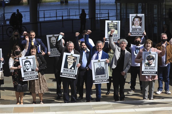 Families of victims of the Ballymurphy massacre react after an inquest ruled that 10 people killed during a military operation in west Belfast 50 years ago were “entirely innocent,” Belfast, Northern Ireland, May 11, 2021 (AP photo by Peter Morrison).