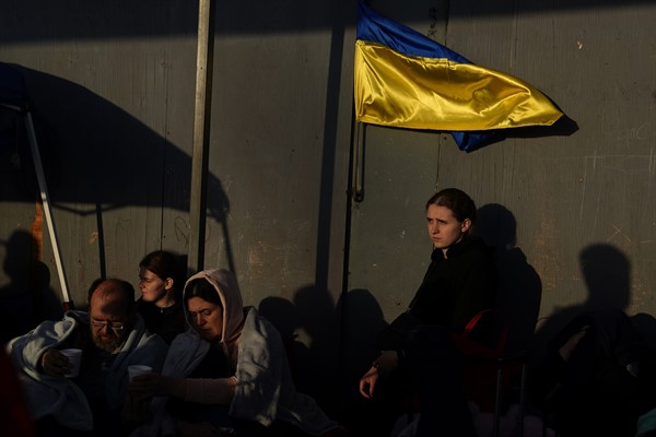 Ukrainian refugees wait near the U.S. border, April 4, 2022, in Tijuana, Mexico (AP photo by Gregory Bull).