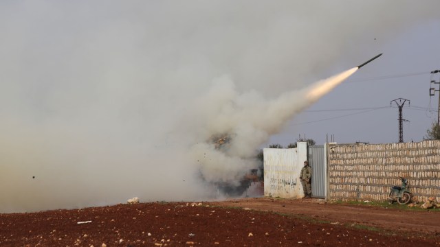 Turkish soldiers fire a missile at a Syrian government-held position