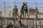 Migrants climb the fences separating the Spanish enclave of Melilla from Morocco in Melilla, Spain, June 24, 2022 (AP photo by Javier Bernardo).