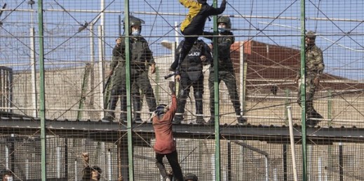 Migrants climb the fences separating the Spanish enclave of Melilla from Morocco in Melilla, Spain, June 24, 2022 (AP photo by Javier Bernardo).