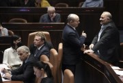 Then-Israeli Prime Minister Naftali Bennett, center, speaks with lawmaker Mansour Abbas ahead of the vote to dissolve the Knesset, in Jerusalem, June 30, 2022 (AP photo by Ariel Schalit).