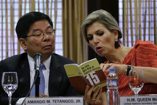 Queen Maxima of the Netherlands, right, the U.N. Secretary-General’s Special Advocate (UNSGSA) for Inclusive Finance for Development, looks at a book with the Governor of the Central Bank of the Philippines, July 1, 2015 (AP Photo by Aaron Favila).