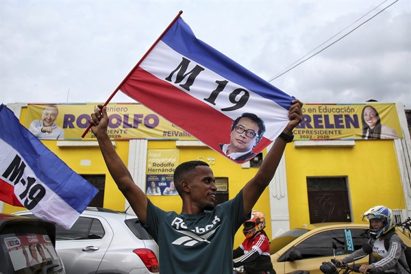 A supporter celebrates after former leftist rebel Gustavo Petro won a runoff presidential election in Cali, Colombia, June 19, 2022 (AP photo by Andres Quintero).