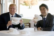 Then-U.S. President Donald Trump and then-Japanese Prime Minister Shinzo Abe hold up hats reading “Donald and Shinzo, Make Alliance Even Greater” in Kawagoe, Japan, Nov. 5, 2017 (AP photo by Andrew Harnik).