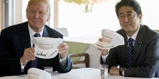 Then-U.S. President Donald Trump and then-Japanese Prime Minister Shinzo Abe hold up hats reading “Donald and Shinzo, Make Alliance Even Greater” in Kawagoe, Japan, Nov. 5, 2017 (AP photo by Andrew Harnik).