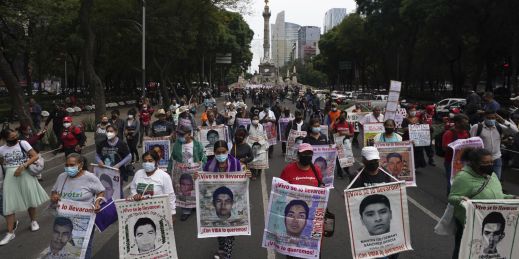 Family members and friends participate in a march seeking justice for the missing 43 Ayotzinapa students in Mexico City