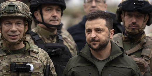 Ukrainian President Volodymyr Zelenskyy poses for a photo with soldiers after attending a national flag-raising ceremony in the liberated city of Izium.