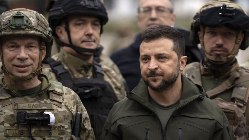 Ukrainian President Volodymyr Zelenskyy poses for a photo with soldiers after attending a national flag-raising ceremony in the liberated city of Izium.