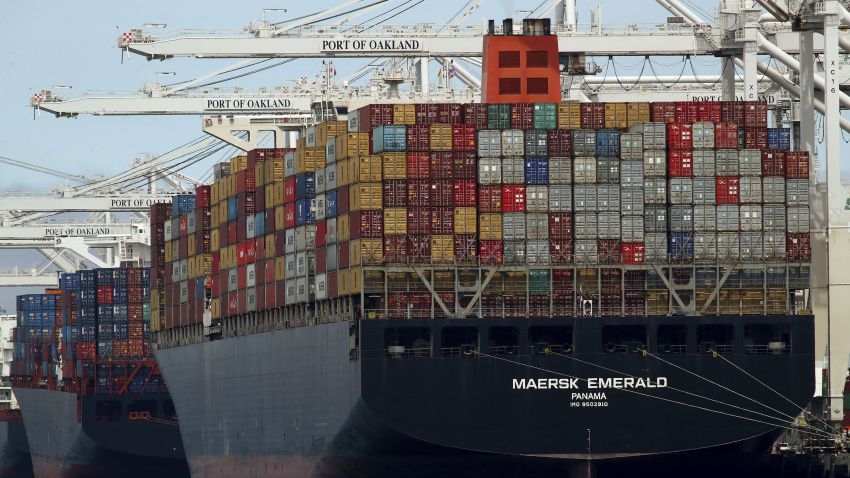 A container ship participating in globalized trade is unloaded in California.