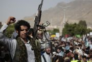 A Houthi supporter carries a weapon during a protest against the U.S. and Saudi Arabia in Yemen.