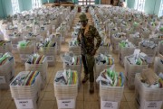 In Kenya (in Africa), a guard watches over ballots, once a sign of good governance in the battle between democracy vs autocracy