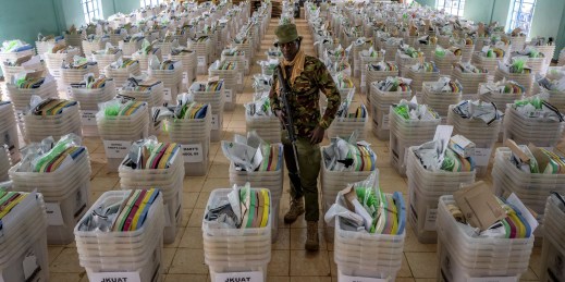 In Kenya (in Africa), a guard watches over ballots, once a sign of good governance in the battle between democracy vs autocracy